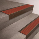 Bronze finish 66x55mm raked back aluminium stair nosing with a Rustic Castellated insert, fitted to interior steps