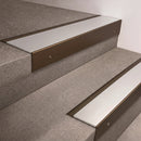 Bronze finish 66x55mm raked back aluminium stair nosing with a Satin Aluminium insert, fitted to interior steps