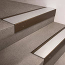 Bronze finish 66x55mm raked back aluminium stair nosing with a Satin Aluminium insert, fitted to interior steps