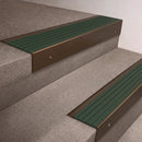 Bronze finish 66x55mm raked back aluminium stair nosing with a Spruce Castellated insert, fitted to interior steps