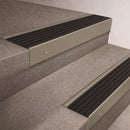 Light Bronze finish 66x55mm raked back aluminium stair nosing with a Black Castellated insert, fitted to interior steps