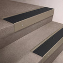 Light Bronze finish 66x55mm raked back aluminium stair nosing with a Black Smooth Textured insert, fitted to interior steps