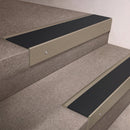 Light Bronze finish 66x55mm raked back aluminium stair nosing with a Black Smooth Textured insert, fitted to interior steps