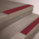 Light Bronze finish 66x55mm raked back aluminium stair nosing with a Claret Castellated insert, fitted to interior steps