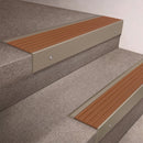 Light Bronze finish 66x55mm raked back aluminium stair nosing with a Fawn Castellated insert, fitted to interior steps