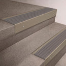Light Bronze finish 66x55mm raked back aluminium stair nosing with a Flint Castellated insert, fitted to interior steps