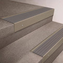 Light Bronze finish 66x55mm raked back aluminium stair nosing with a Flint Castellated insert, fitted to interior steps