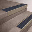 Light Bronze finish 66x55mm raked back aluminium stair nosing with a Granite Castellated insert, fitted to interior steps