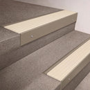 Light Bronze finish 66x55mm raked back aluminium stair nosing with a Ivory Castellated insert, fitted to interior steps