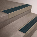 Light Bronze finish 66x55mm raked back aluminium stair nosing with a Jade Castellated insert, fitted to interior steps