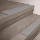 Light Bronze finish 66x55mm raked back aluminium stair nosing with a Light Grey Smooth Textured insert, fitted to interior steps