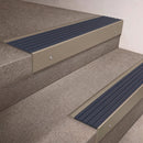 Light Bronze finish 66x55mm raked back aluminium stair nosing with a Mid Blue Castellated insert, fitted to interior steps