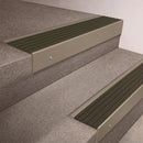 Light Bronze finish 66x55mm raked back aluminium stair nosing with a Olive Castellated insert, fitted to interior steps