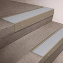 Light Bronze finish 66x55mm raked back aluminium stair nosing with a Polar Grey Smooth Textured insert, fitted to interior steps