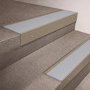 Light Bronze finish 66x55mm raked back aluminium stair nosing with a Polar Grey Smooth Textured insert, fitted to interior steps