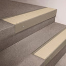 Light Bronze finish 66x55mm raked back aluminium stair nosing with a Porth Stone Smooth Textured insert, fitted to interior steps
