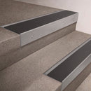 Mill Aluminium finish 66x55mm raked back aluminium stair nosing with a Black Anodised Aluminium insert, fitted to interior steps