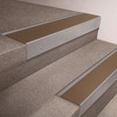Mill Aluminium finish 66x55mm raked back aluminium stair nosing with a Bronze Aluminium insert, fitted to interior steps