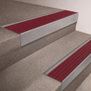 Mill Aluminium finish 66x55mm raked back aluminium stair nosing with a Claret Castellated insert, fitted to interior steps