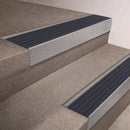 Mill Aluminium finish 66x55mm raked back aluminium stair nosing with a Granite Castellated insert, fitted to interior steps