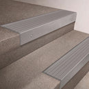 Mill Aluminium finish 66x55mm raked back aluminium stair nosing with a Light Grey Castellated insert, fitted to interior steps