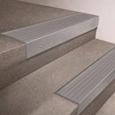 Mill Aluminium finish 66x55mm raked back aluminium stair nosing with a Light Grey Castellated insert, fitted to interior steps