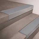 Mill Aluminium finish 66x55mm raked back aluminium stair nosing with a Light Grey Smooth Textured insert, fitted to interior steps
