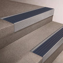 Mill Aluminium finish 66x55mm raked back aluminium stair nosing with a Mid Blue Castellated insert, fitted to interior steps
