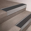 Mill Aluminium finish 66x55mm raked back aluminium stair nosing with a Nimbus Castellated insert, fitted to interior steps