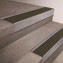 Mill Aluminium finish 66x55mm raked back aluminium stair nosing with a Olive Castellated insert, fitted to interior steps