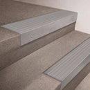 Mill Aluminium finish 66x55mm raked back aluminium stair nosing with a Polar Grey Castellated insert, fitted to interior steps