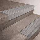 Mill Aluminium finish 66x55mm raked back aluminium stair nosing with a Polar Grey Castellated insert, fitted to interior steps