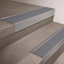 Mill Aluminium finish 66x55mm raked back aluminium stair nosing with a Polar Grey Smooth Textured insert, fitted to interior steps
