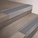 Mill Aluminium finish 66x55mm raked back aluminium stair nosing with a Polar Grey Smooth Textured insert, fitted to interior steps