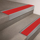 Mill Aluminium finish on a 66x55mm raked back stair nosing with a Poppy red insert, fitted to interior steps