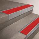 Mill Aluminium finish on a 66x55mm raked back stair nosing with a Poppy red insert, fitted to interior steps