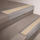 Mill Aluminium finish 66x55mm raked back aluminium stair nosing with a Porth Stone Smooth Textured insert, fitted to interior steps