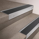Satin Aluminium finish 66x55mm raked back aluminium stair nosing with a Black Anodised Aluminium insert, fitted to interior steps