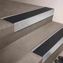 Satin Aluminium finish 66x55mm raked back aluminium stair nosing with a Black Smooth Textured insert, fitted to interior steps