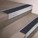 Satin Aluminium finish 66x55mm raked back aluminium stair nosing with a Granite Castellated insert, fitted to interior steps