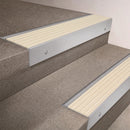 Satin Aluminium finish 66x55mm raked back aluminium stair nosing with a Ivory Castellated insert, fitted to interior steps