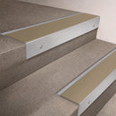 Satin Aluminium finish 66x55mm raked back aluminium stair nosing with a Light Bronze Aluminium insert, fitted to interior steps