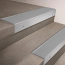 Satin Aluminium finish 66x55mm raked back aluminium stair nosing with a Light Grey Smooth Textured insert, fitted to interior steps