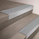 Satin Aluminium finish 66x55mm raked back aluminium stair nosing with a Light Grey Smooth Textured insert, fitted to interior steps