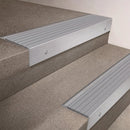 Satin Aluminium finish 66x55mm raked back aluminium stair nosing with a Polar Grey Castellated insert, fitted to interior steps