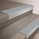 Satin Aluminium finish 66x55mm raked back aluminium stair nosing with a Polar Grey Smooth Textured insert, fitted to interior steps