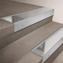 Satin Aluminium finish 66x55mm raked back aluminium stair nosing with a Polished Aluminium insert, fitted to interior steps