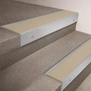 Satin Aluminium finish 66x55mm raked back aluminium stair nosing with a Porth Stone Smooth Textured insert, fitted to interior steps