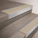 Satin Aluminium finish 66x55mm raked back aluminium stair nosing with a Porth Stone Smooth Textured insert, fitted to interior steps