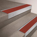 Satin Aluminium finish 66x55mm raked back aluminium stair nosing with a Rustic Castellated insert, fitted to interior steps